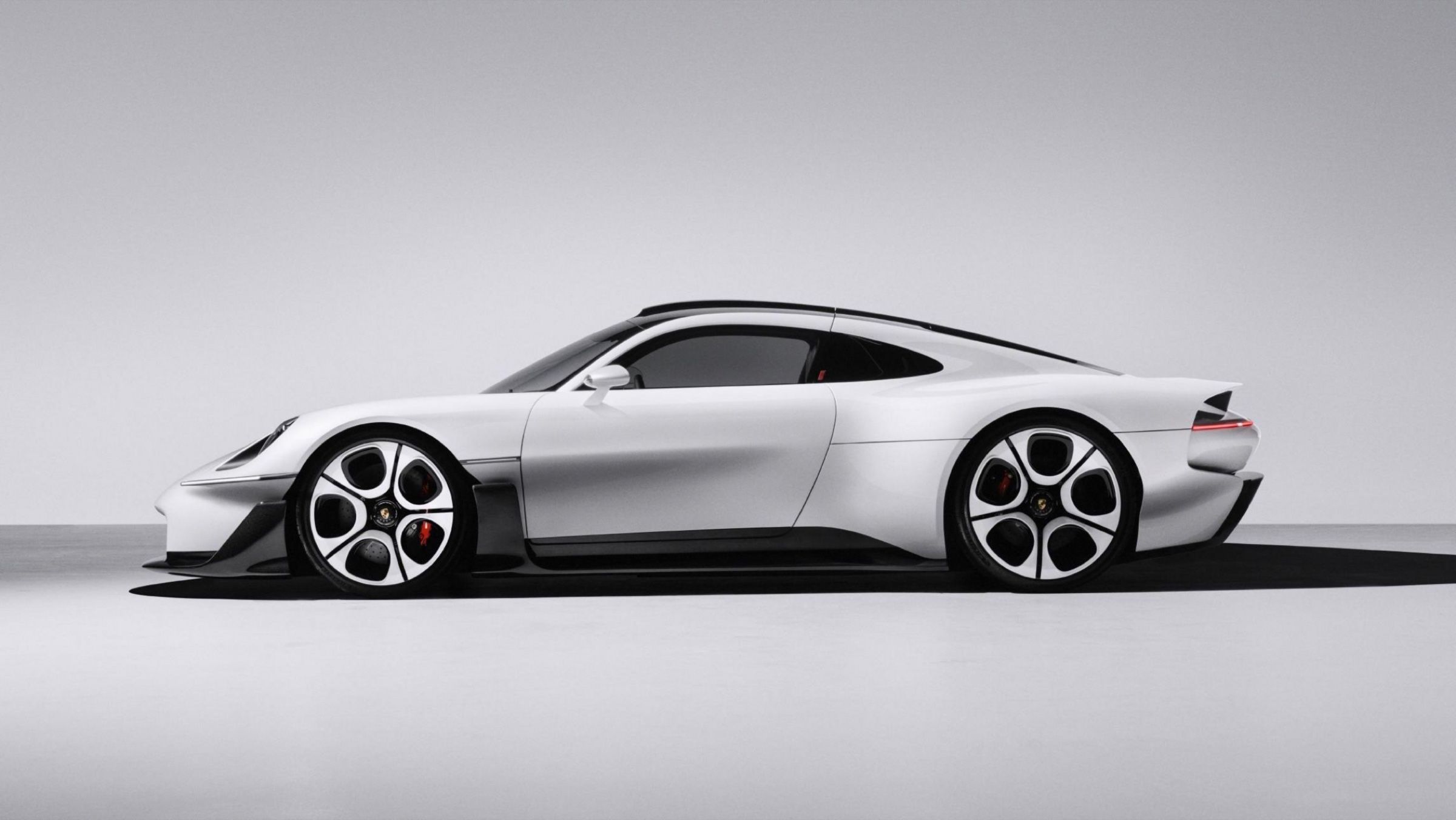 Side profile of the Mission S showing the long rear deck of a mid-engined car and the roofline running back under the wing