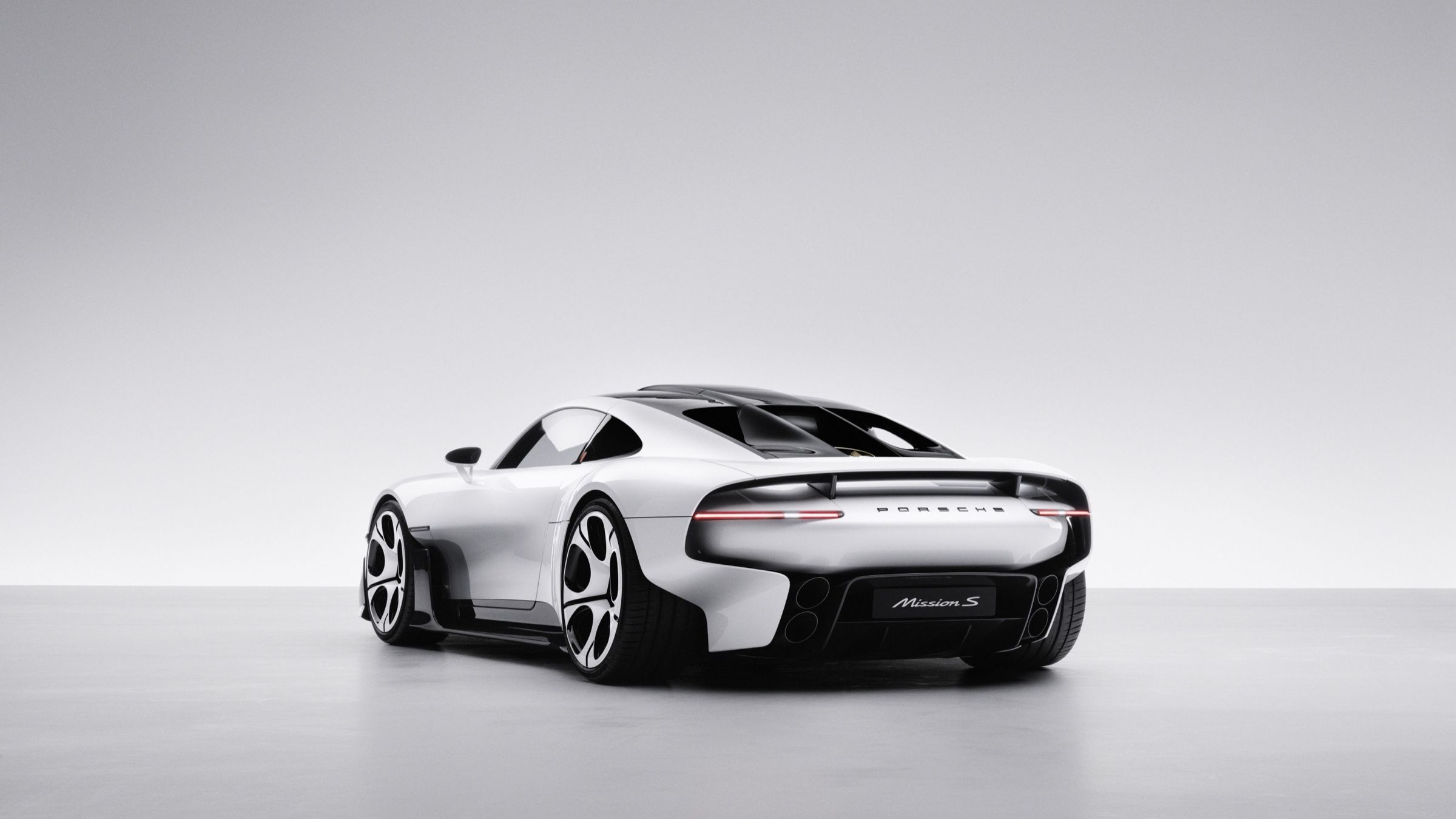 Rear three-quarter view with the full-width light bar and Mission S script on the tail