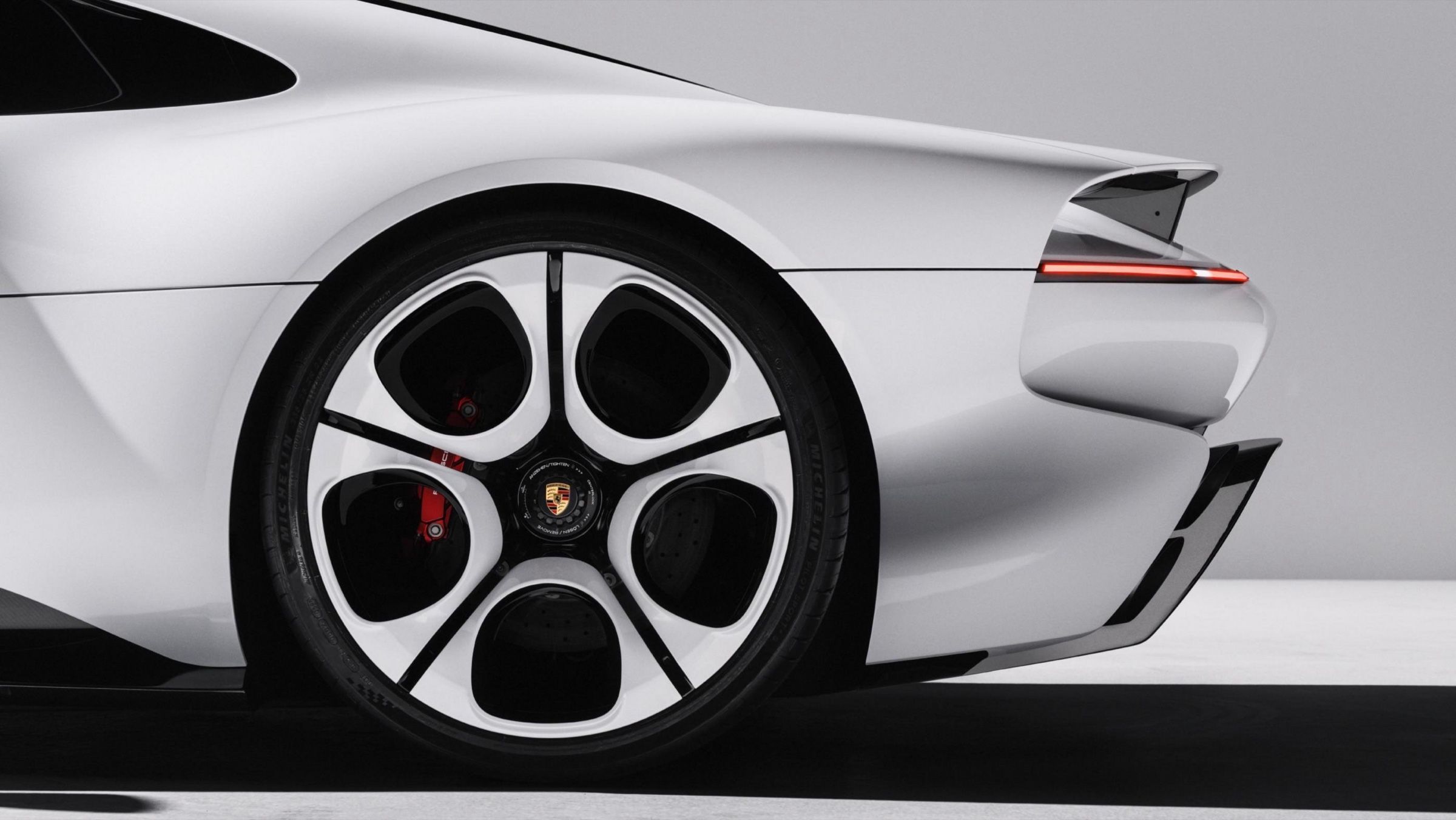 Rear wheel and haunch, with the tail lamp running out toward the wing