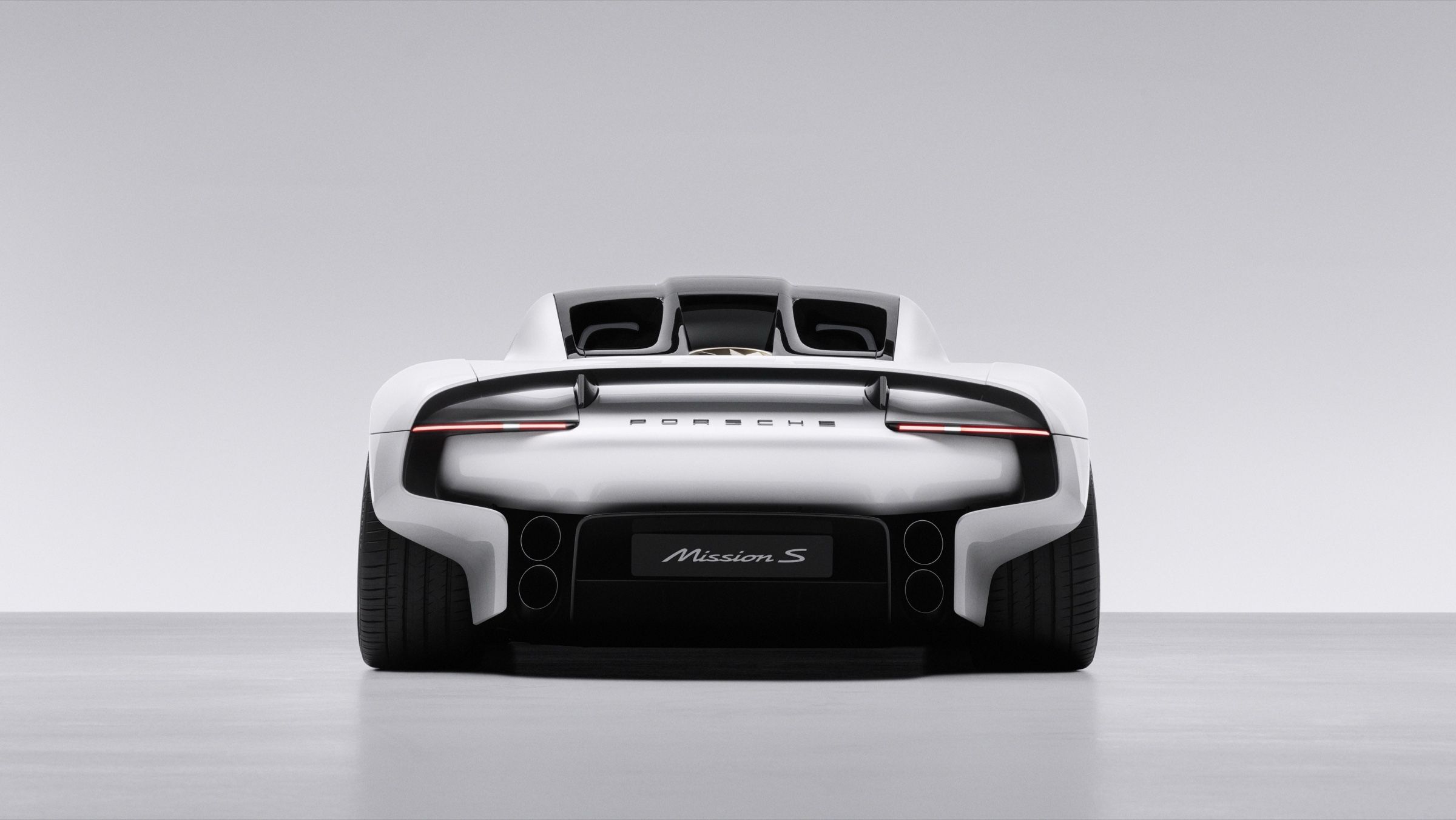 Straight rear view showing the integrated wing, the light bar, the Mission S badge and four round outlets in the diffuser